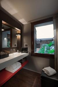 a bathroom with a sink and a large window at Charming House Iqs in Venice