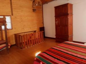 En eller flere senge i et værelse på Cabañas Río Los Nogales