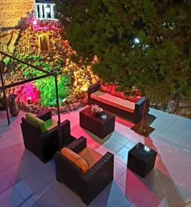a patio with couches and tables and lights at Tell Madaba Hotel in Madaba
