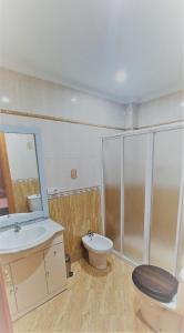 a bathroom with a toilet and a sink and a shower at Apartamentos La Libertad Estepona in Estepona +38 photos