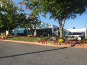 a building with a flower garden in front of it at Express Inn and Suites in Gastonia