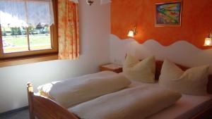 a bedroom with two beds and a window at Haus Emberger in Gerlos