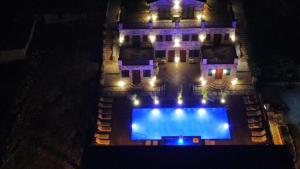an aerial view of a house with a swimming pool at night at Limni Resort in Ksamil