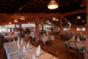 a dining room with tables and chairs and lights at Hotel Cap Saint Louis in Saint-Louis