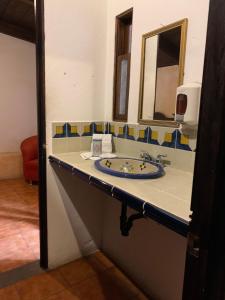 a bathroom with a sink and a mirror at Hotel T KON T in Antigua Guatemala