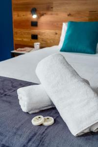 a bed with white towels and two rings on it at Hunter Studios - Maitland in Maitland