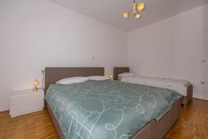 Posteľ alebo postele v izbe v ubytovaní Apartments Jarmila