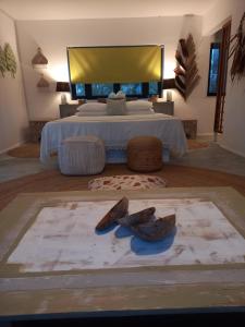 a bedroom with a large bed with a yellow headboard at Mamy Cherie in Rodrigues Island