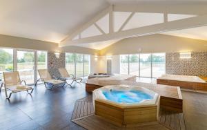 a large room with a hot tub in the middle at Lagrange Vacances Le Village de la Mer in Talmont