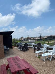 a picnic table and chairs on a patio at Belles Sea Inn in Port Aransas