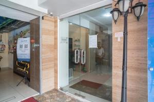 a store front with a glass door and a light pole at RedDoorz @ Glodok in Jakarta