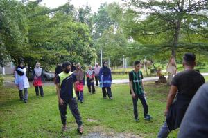 a group of people walking in a park at Anjung Afilia 1 in Kuala Kangsar