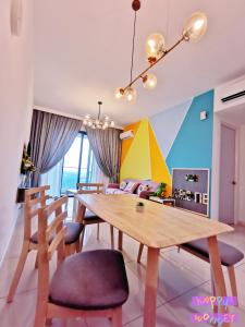 a dining room with a wooden table and chairs at Legoland-Happy Wonder Suite,Elysia-8pax,100MBS in Nusajaya