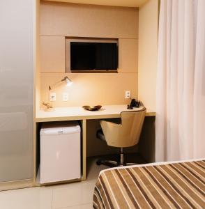 a bathroom with a sink and a television at Lagoon Prime Hotel in Lagoa Santa