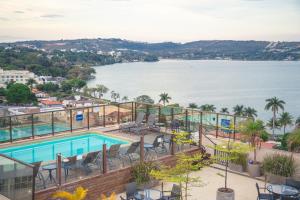 a large pool of water with a view of the ocean at Lagoon Prime Hotel in Lagoa Santa
