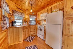 a kitchen with wooden cabinets and a white refrigerator at Kara's Cottage in Johnson City