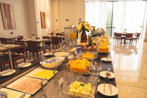a dining room table filled with plates of food at Lagoon Prime Hotel in Lagoa Santa