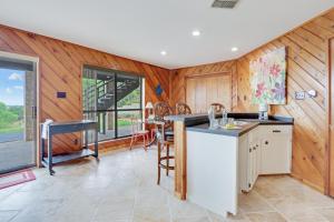 a kitchen with wooden walls and a table with chairs at On Top of the World in New Braunfels