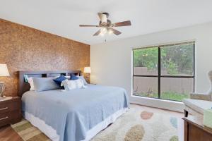 a bedroom with a bed and a ceiling fan at On Top of the World in New Braunfels