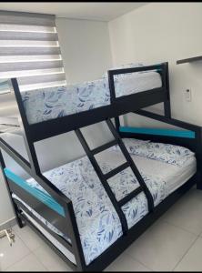 a black bunk bed in a room at Apartamento - Velas al Mar, Santa Marta in Gaira +30 photos
