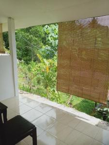 a room with a window with a view of a garden at Tiu Kelep Homestay in Senaru