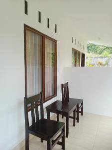 two chairs and a table in a room at Tiu Kelep Homestay in Senaru