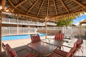 a patio with a table and chairs and a pool at Montrose Valley Lodge in Montrose