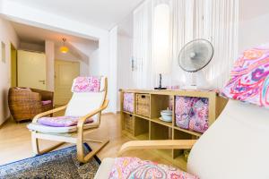 a living room with a chair and a desk at CGN Apartments - Deutzer Bruecke in Cologne