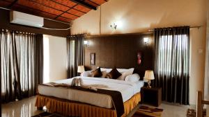 a bedroom with a large bed in a room at BADAMI HERITAGE RESORT in Badami