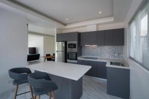 a kitchen with a white counter and blue cabinets at Orchid Paradise Homes OPV429 in Hua Hin