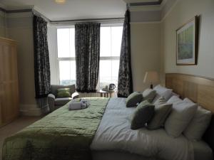 a bedroom with a large bed with a large window at Bailey Ground Lodge in Seascale