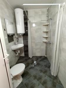 a bathroom with a toilet and a sink and a shower at Apartment RELAX in Tsarevo in Tsarevo