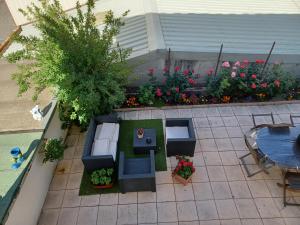 a patio with a table and chairs and flowers at STUDIO LE MONT-CENIS, GARAGE pour motards et cyclistes, gare a 800m in Fourneaux