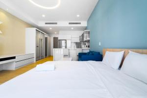 a large white bed in a room with a kitchen at Mcity at Jalan Ampang in Kuala Lumpur