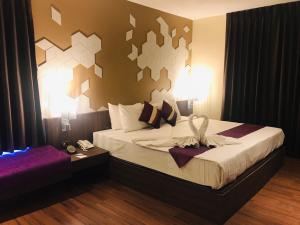 a hotel room with a bed with a bow on it at Paradiso Boutique Suites in Bangkok