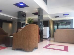 a lobby with a chair in a building at Paradiso Boutique Suites in Bangkok