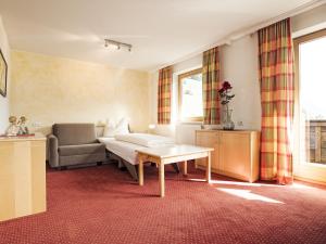 a living room with a couch and a table at Fiechtl Apartments in Stumm