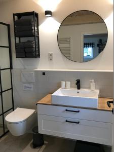 a bathroom with a white sink and a mirror at Hygge-Huus-Burhave in Burhave +46 photos