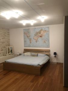 a bedroom with a bed with a map on the wall at Appartamento Torbole Conca D'Oro in Nago-Torbole