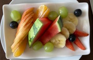 a plate of fruit and vegetables on a plate at Kelston Guest House in Weymouth