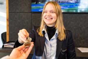 a woman is holding a object in her hand at Europarcs Zuiderzee in Biddinghuizen
