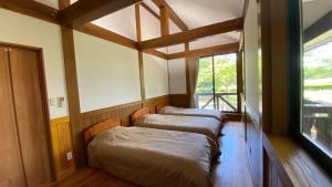 Gulta vai gultas numurā naktsmītnē Tabinoteitaku Yakurai Cottage