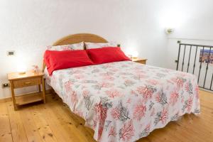 a bedroom with a large bed with red pillows at Casa Resilienza Vico Equense - 5 min dal mare in Vico Equense