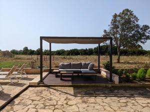 a pavilion with a couch sitting on a patio at Punta de Vistalegre in Porto Cristo