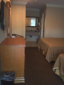 a hotel room with two beds and a television at Hyland Motel Van Nuys in Van Nuys