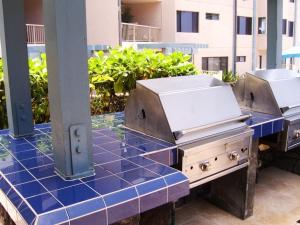 a couple of grill equipment on top of a blue counter at New! Kona Reef Resort Oceanfront 2 Bdrm, 2 Bath D-11 Right on the Ocean! Casago Kona in Kailua-Kona
