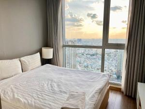 Кровать или кровати в номере Vinhomes Binh Thanh Official Luxury Apartment