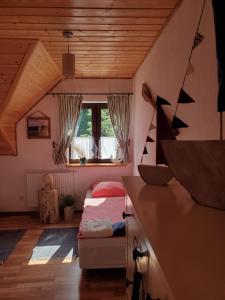 a bedroom with a bed and a window at Zagroda Berezanka 600-739-125 in Polańczyk