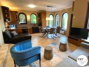 a living room with a kitchen and a dining room at ARTtrend Luxury Villa in Tihany