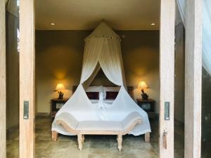 Un ou plusieurs lits dans un hébergement de l'établissement Kailash Bali